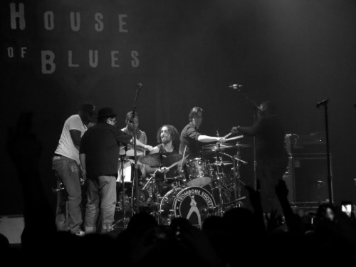 The entire band playing the drum kit 